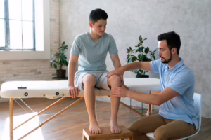 Doctor treating patient with knee pain to improve movement and reduce discomfort
