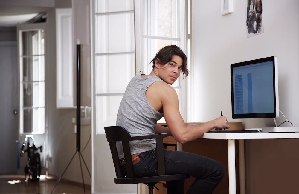 Teenager sitting with slouched posture while using a phone or laptop